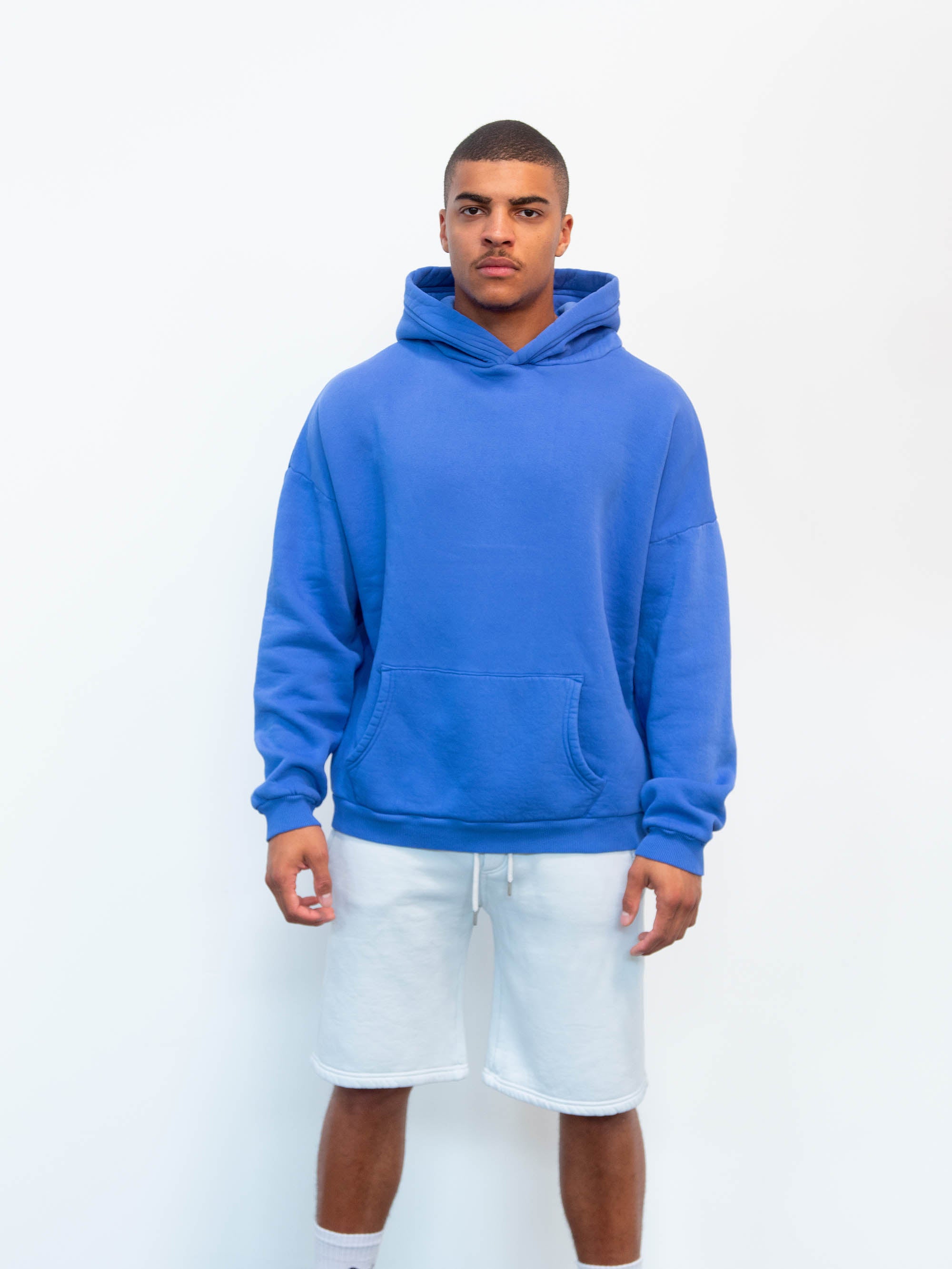 Model wearing Blank hoodie in blue