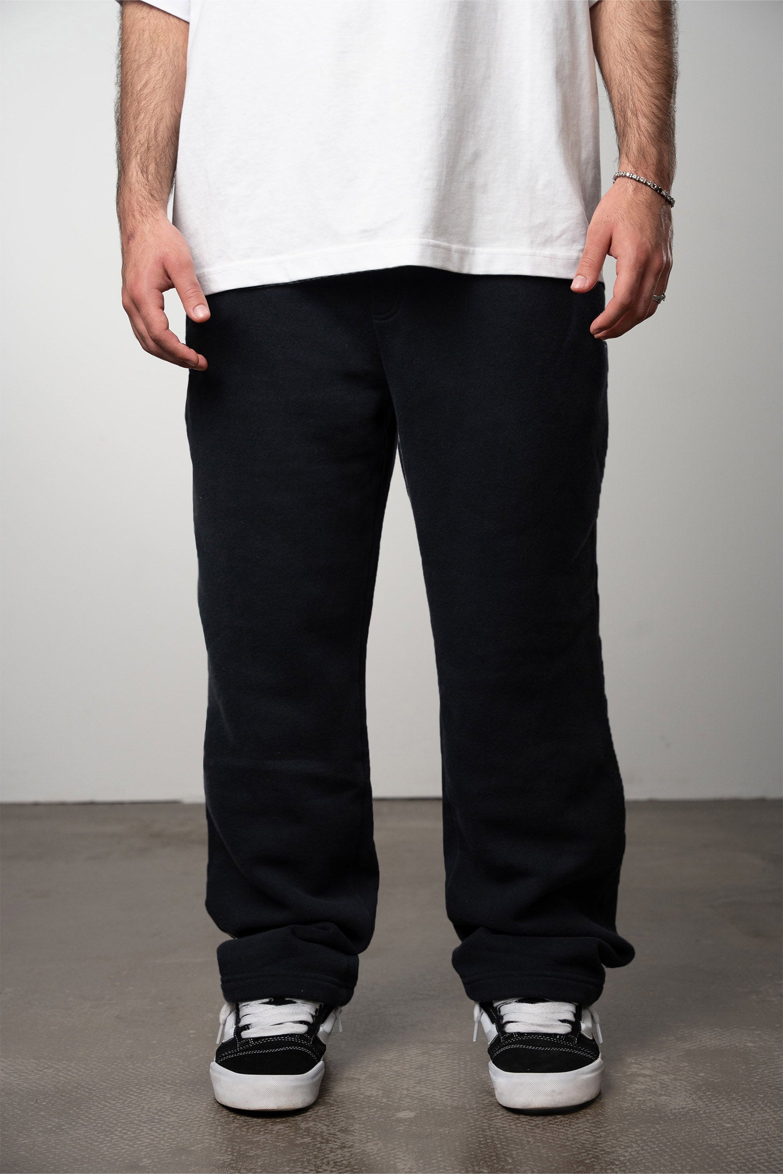 Model is wearing a premium black blank jogger with no moq for clothing brand startups