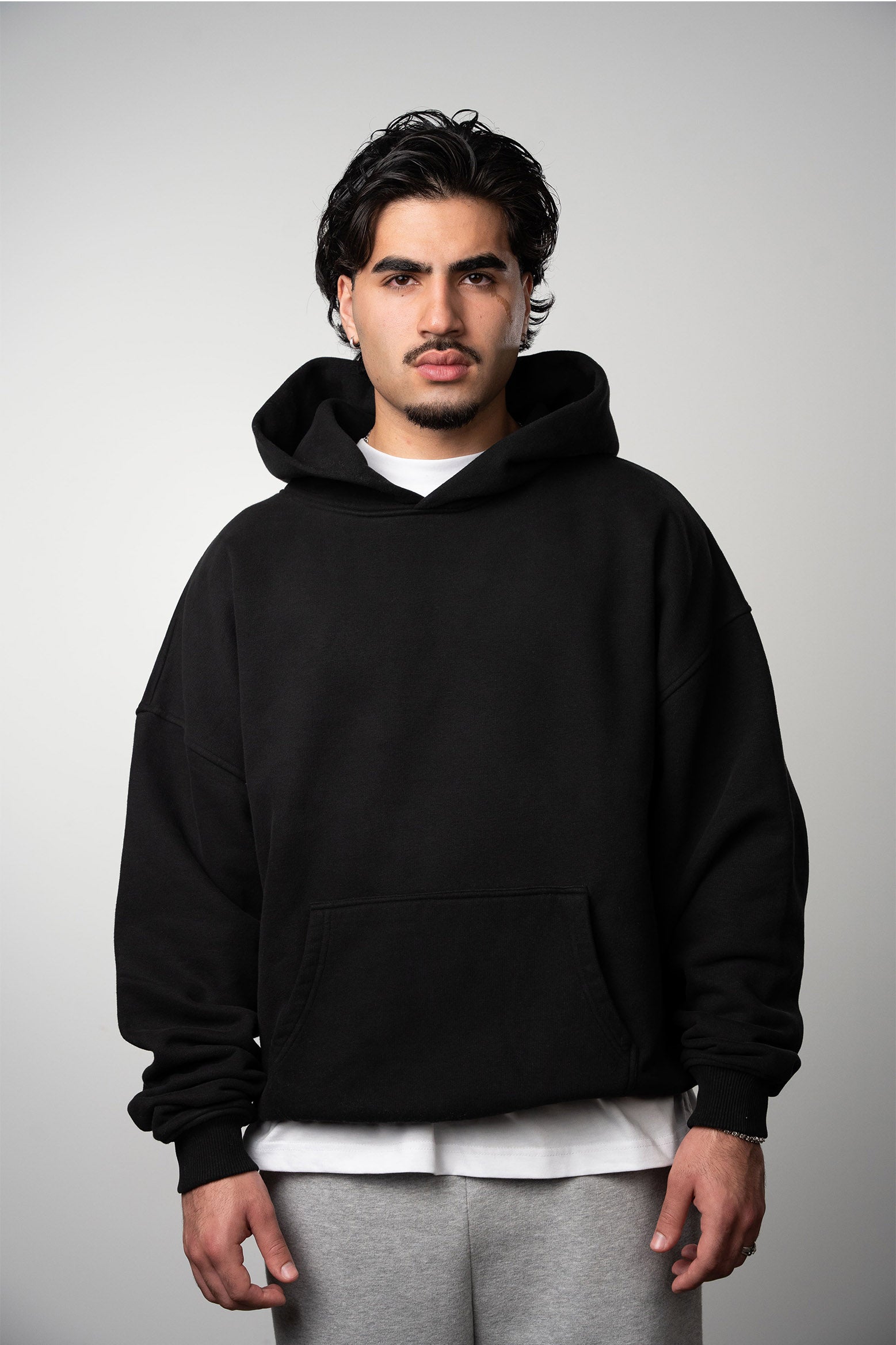Model wearing high quality Blank hoodie in color washed black for streetwear brands
