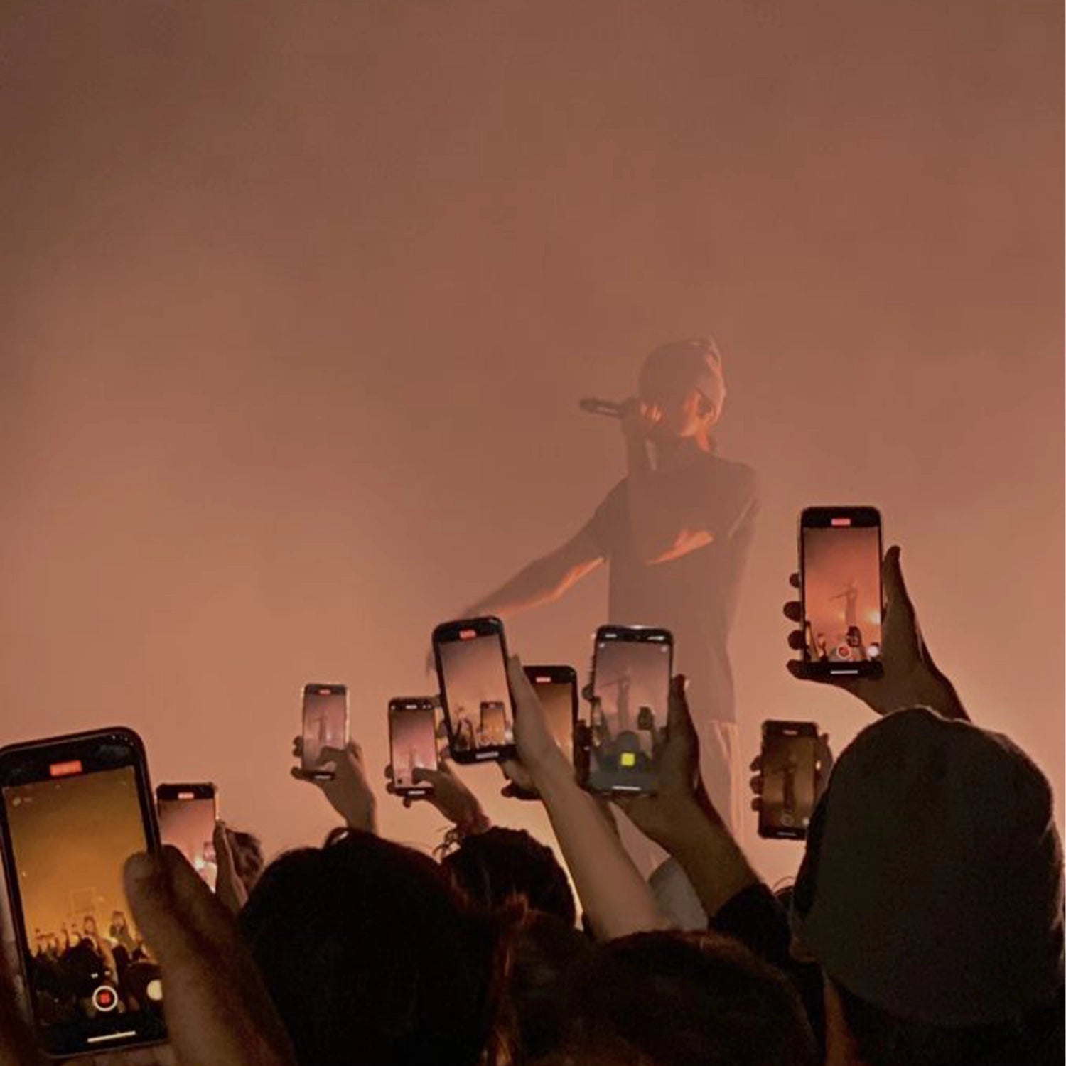 Artist is wearing his merchandise on a stage