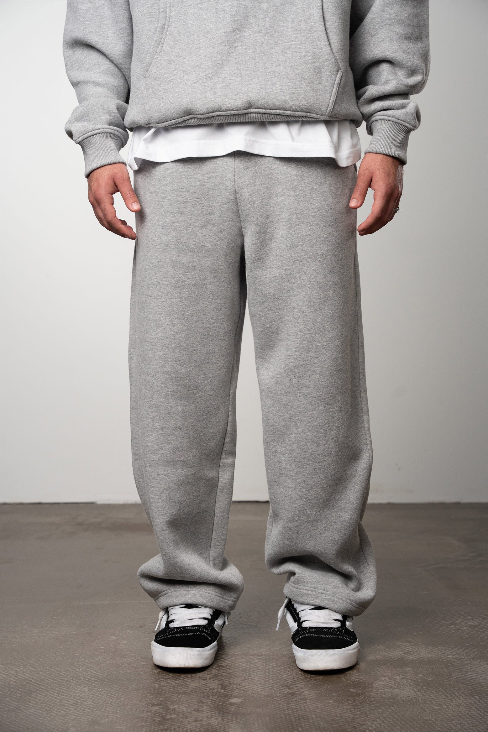Model wearing melange grey pant blank with oversized and open leg fit