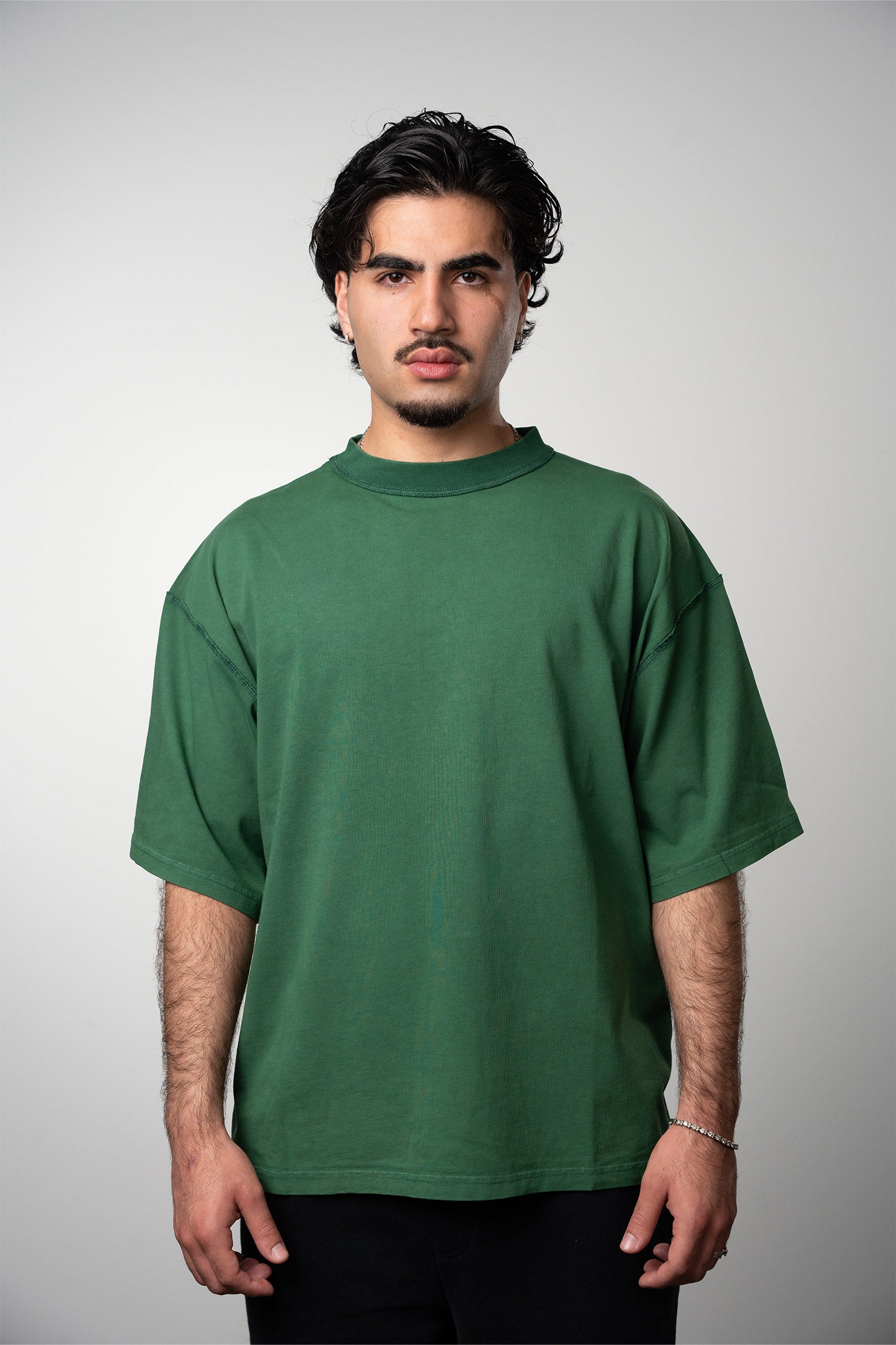 Model wearing the LEMUTA Blank tee in the color juniper green