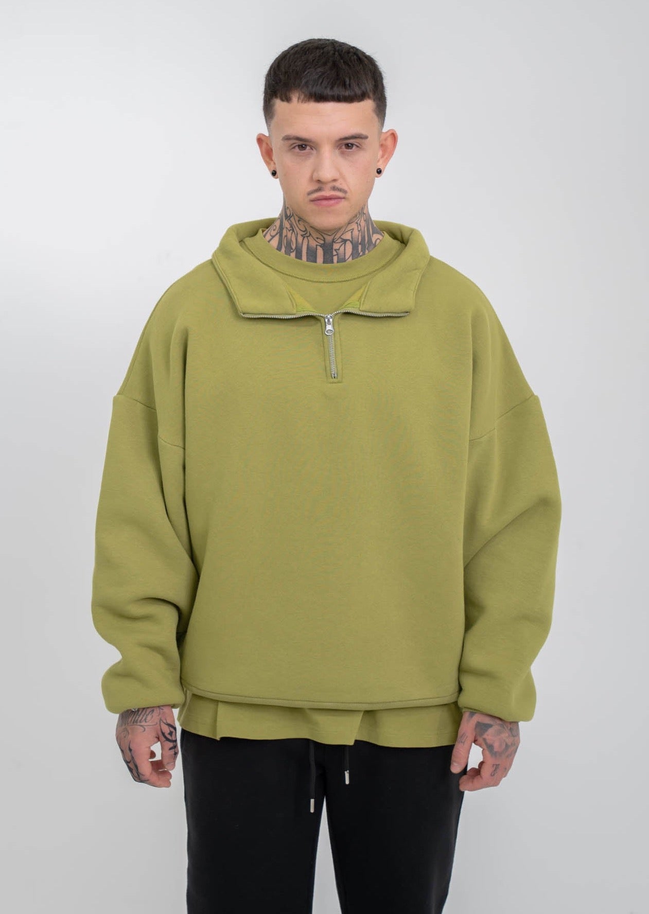 Model is wearing a green half zip Blank for wholesale